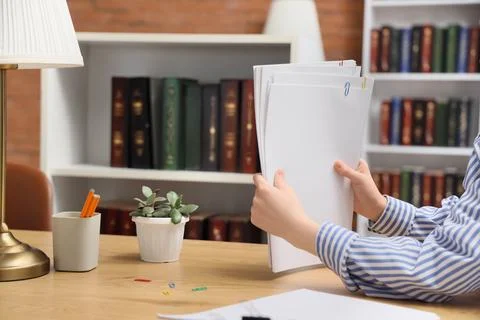 Female hands with stack of documents at desk in office Stock Photos