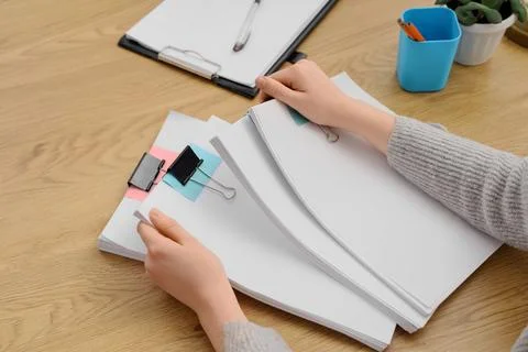 Female hands with stack of documents on desk in office Stock Photos