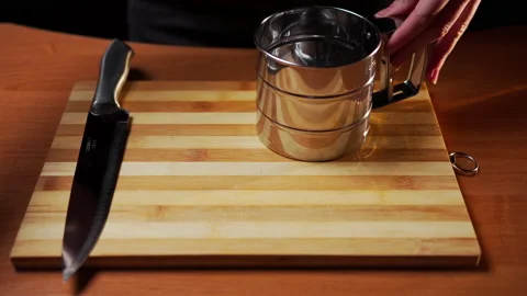 Female hands stack on a wooden board on the table metal kitchen utensils Stockbeeldmateriaal 149181939