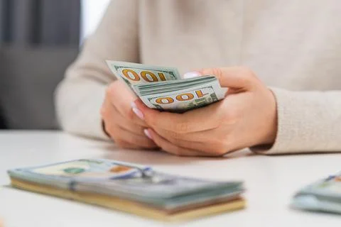 Female hands stacking counted dollar bills Stock-Fotos