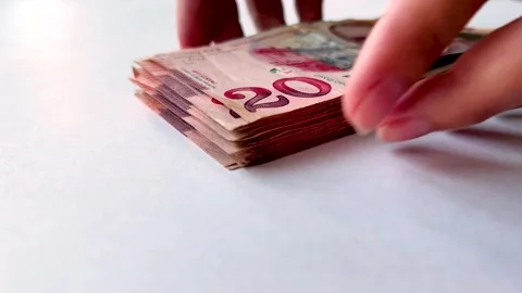 Female hands stacking paper banknote into stack on white table 動画素材 340428010