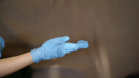Female hands take off and throw away medical blue gloves 스톡 동영상 129665101
