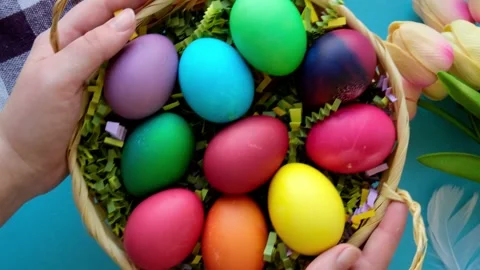 Female hands take a basket with colored Easter eggs top view close-up Stock Footage 235808470