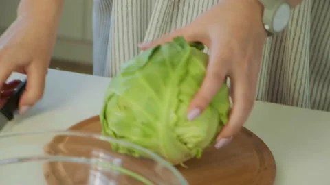 Female hands take big cabbage head and put on the wooden cutting board. Chopping Stock Footage 144756963
