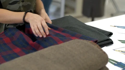 Female hands take clothes from a stack Stock Footage 89950812