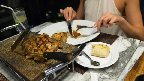 Female hands take from the dish grilled vegetables and meat. Stock Footage 86284353