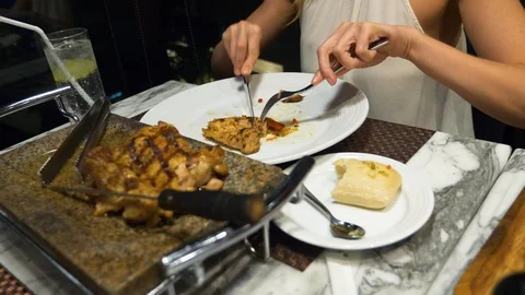 Female hands take from the dish grilled vegetables and meat. Stock Footage 86284428