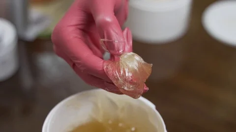 Female hands take a paste for shugaring. 100 frames Stock Footage 124498460