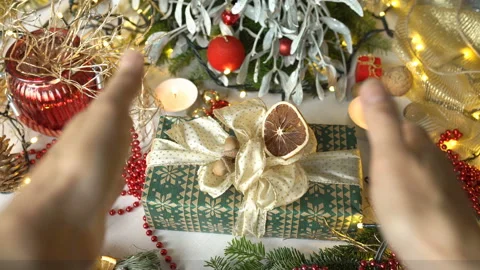 Female hands taking christmas present from the table Stock Footage 99221392