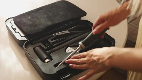 Female hands taking a screwdriver from a case and attaching a bit Stock Footage 319781565