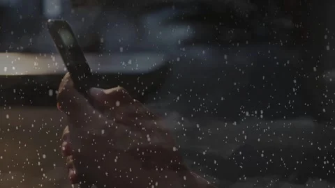 Female hands tapping smartphone beside rainy window, initiating tech UI while Stock Footage 332981937