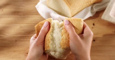 Female hands tear fresh bread. Texture of bread close up. Stock Footage 242446121