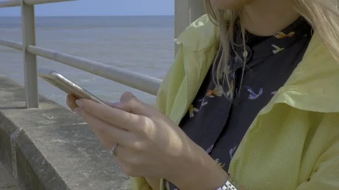 Female hands texting on her mobile on a sunny day Stock Footage 97302192