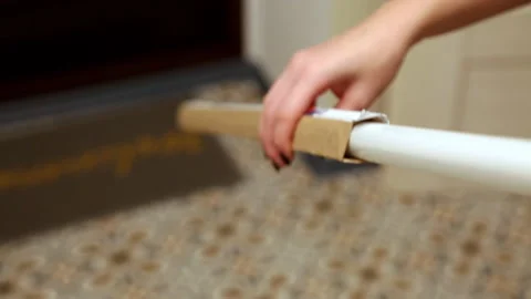 Female hands thrust a long lamp into a box. Full HD Stock Footage 141611510
