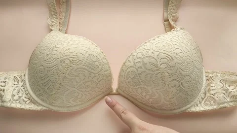 Female hands touch the soft push-up of a womans bust. Womens Underwear Stock Footage 325291528