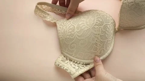 Female hands touch the soft push-up of a womans bust. Womens Underwear Stock Footage 325291530