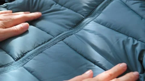 Female hands touching groping material emerald green waterproof fabric of winter Stockbeeldmateriaal 224868092