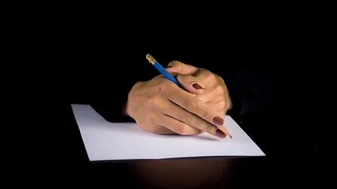 Female hands trying to write a statement.  Fotos de archivo