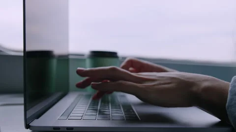 Female hands that type on a laptop while traveling on a train. Remote work Stock Footage 241237806