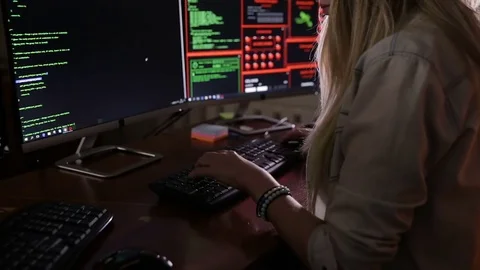 Female hands typing computer code, hacking computer at a dark room. Hacker Stock Footage 69793805