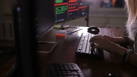 Female hands typing computer code, hacking computer at a dark room. Hacker Stock Footage