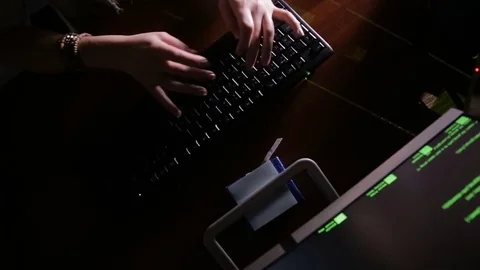 Female hands typing computer code, hacking computer at a dark room. Hacker Stock Footage 69794914