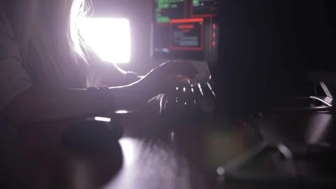 Female hands typing computer code, hacking computer at a dark room. Hacker Stock Footage 70095702