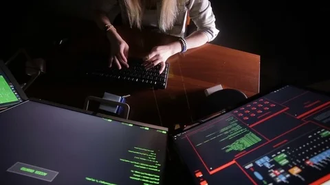 Female hands typing computer code, hacking computer at a dark room. Hacker Stock Footage 70095836
