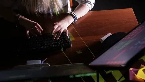 Female hands typing computer code, hacking computer at a dark room. Hacker Stock Footage 70096313