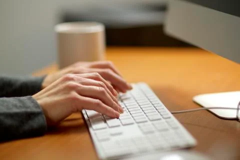 Female hands typing on a computer keyboard working in her office. 写真素材