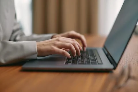 Female hands typing on computer keyboard study or work with laptop software tech 库存照片