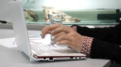 Female hands typing on the keyboard on the background of the aquarium Stock Footage 68397230