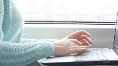 Female hands typing on keyboard of laptop in train. Woman chatting with friends Stock Footage