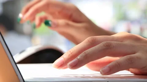 Female hands typing on laptop computer keyboard against bright background Stock Footage 64685101