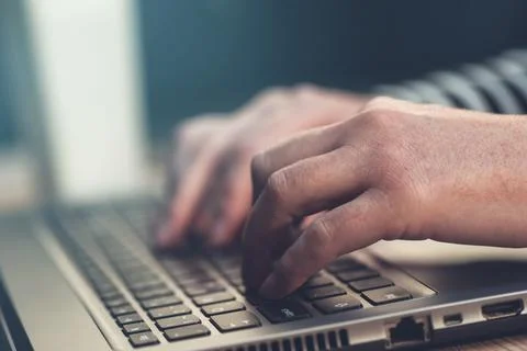 Female hands typing on laptop computer keyboard Stock Photos