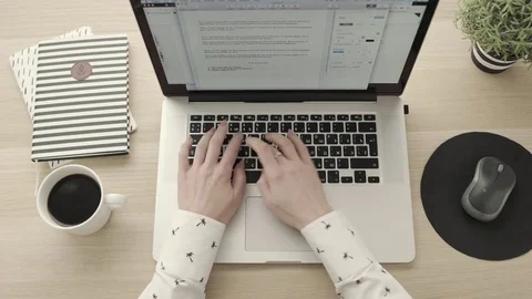 Female hands typing on laptop, drinking coffee. Freelancer workspace overhead Stock Footage 83417293