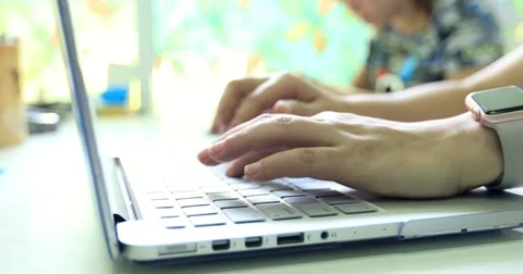 Female hands typing on a laptop keyboard Stock Footage