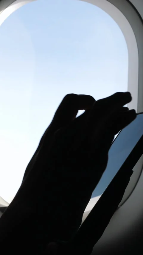 Female Hands Typing on Mobile Phone in Airplane, Sunlight Shining Through Window Stock Footage 294743497
