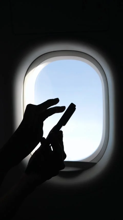 Female Hands Typing on Mobile Phone in Airplane, Sunlight Shining Through Window Stock Footage 294743760
