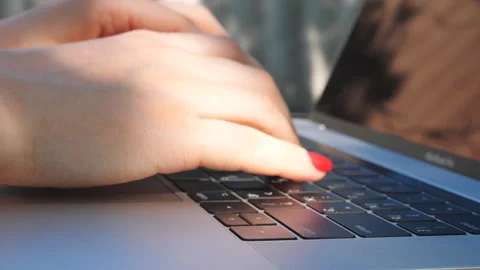 Female hands typing some text on keyboard of notebook. Working at laptop Video stock 267850173