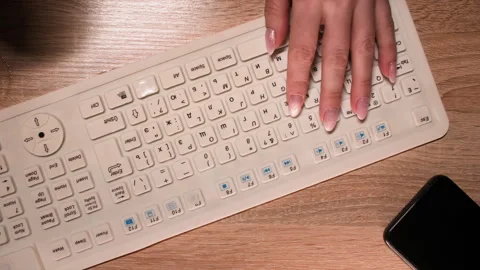 Female hands typing text in dark, then spill cup of tea on white keyboard Stock Footage 312820598