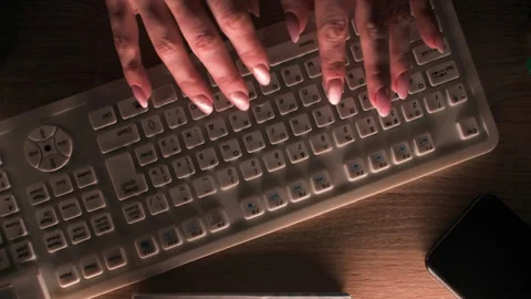 Female hands typing text in dark, then spill cup of tea on white keyboard Stock Footage 312822383