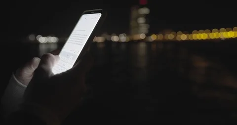 Female hands typing text message smartphone at night city background. Connecting Stock-Footage 129603159