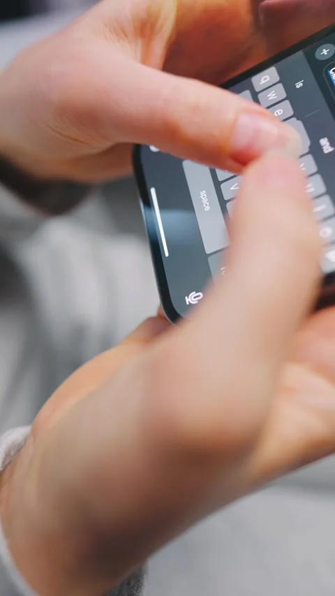Female hands typing text on smartphone close-up. Vertical Stock Footage 342954765