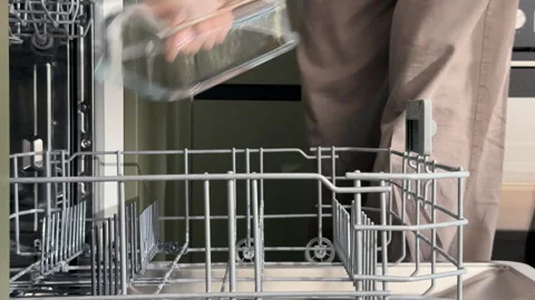 Female hands unloading clean transparent glassware from an open domestic di.. Stock Footage 346159524