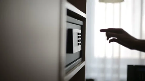 Female hands unlocking combination to safe in the hotel room Stock Footage 48657864