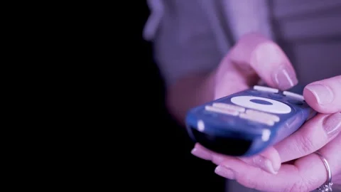 Female Hands Using Blue Streaming Remote Control To Select Movie At Night 库存影片 330176469