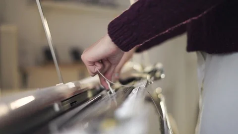 Female hands using knitting machine for weaving pattern in workshop 動画素材 87453332