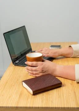 Female hands using laptop while working from home office. Woman typing on key Stock Photos