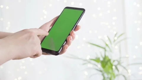 Female hands using mobile phone with green screen Stock Footage 169589400